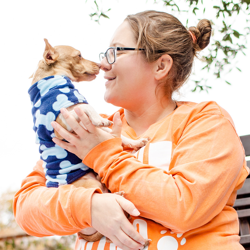 woman nose to nose with dog at austin pets alive
