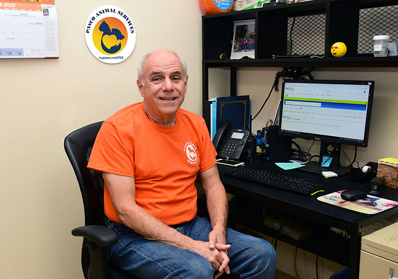 8 Ways to Recruit Volunteers and Keep Them Engaged Richard Deighton at Desk wearing special volunteer shirt Ways to Engage Volunteers web - 8 Ways to Recruit Volunteers and Keep Them Engaged