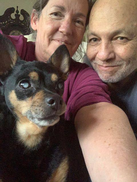 Small dog named Tinkerbell with two people up close to the camera