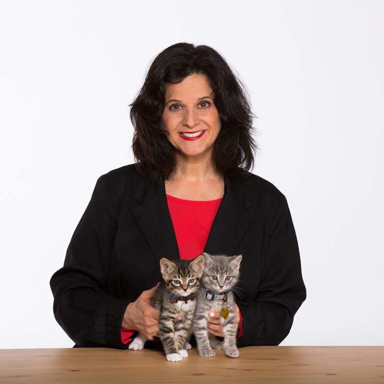 Julie Bank with two kittens smiling at the camera