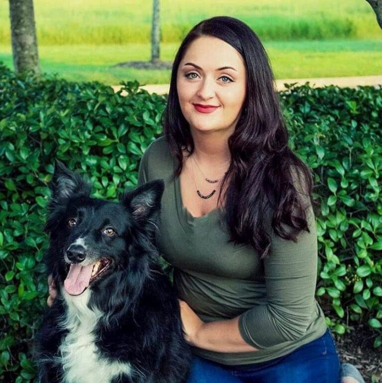 Mara Hartsell sitting with a black and white dog
