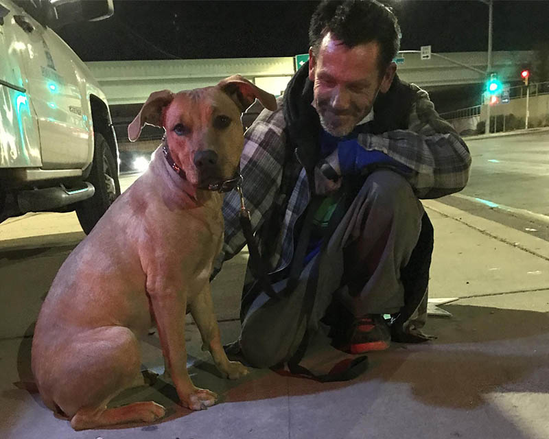 Dog and man experiencing homelessness