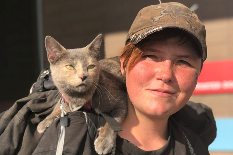 pets.findhelp.com Guide - woman with a cat around her shoulders at Pima Animal Care Center - Human Animal Support Services